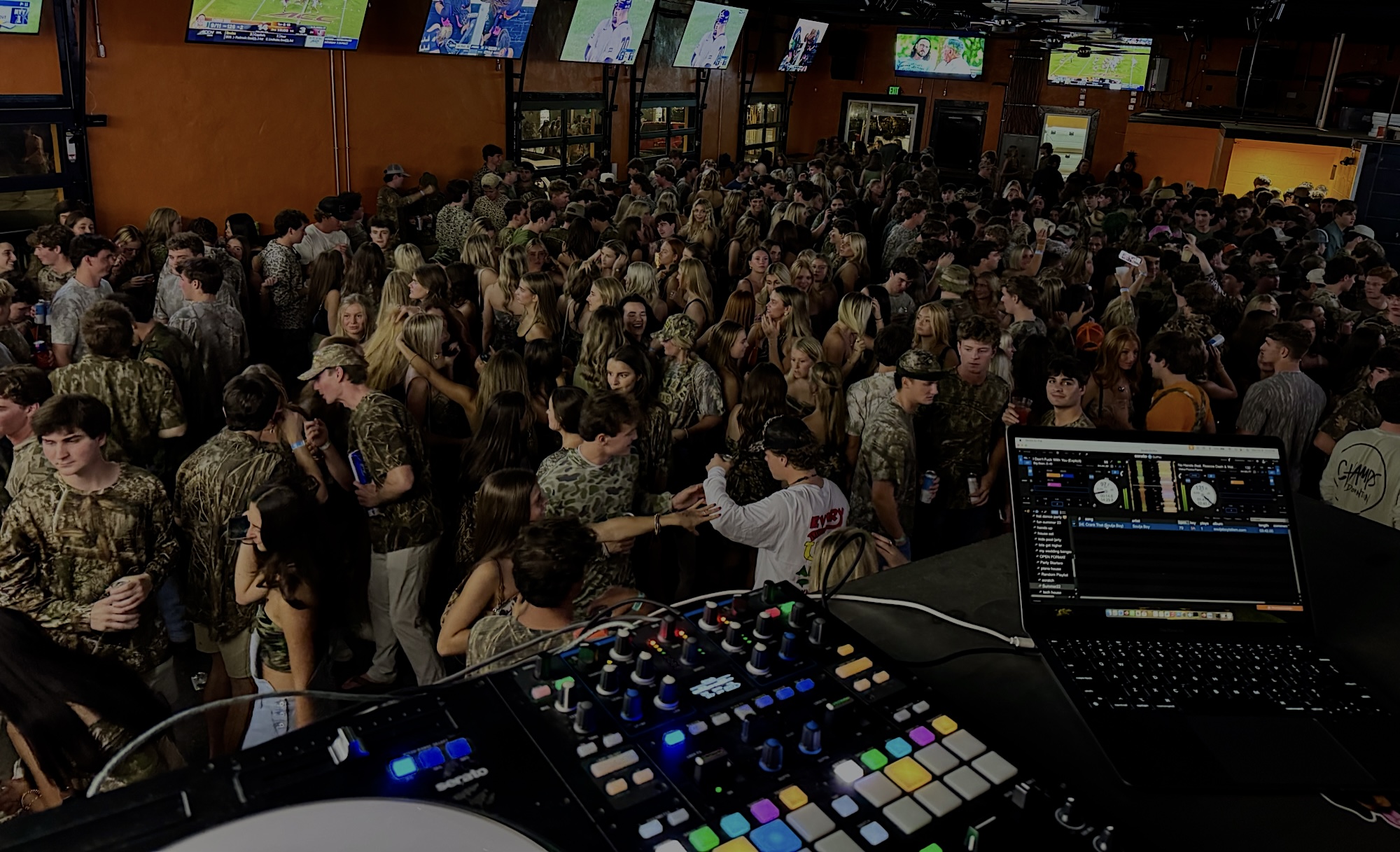 DJ booth overlooking a packed dance floor