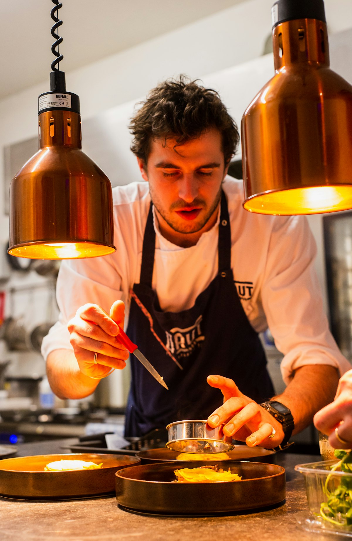 A chef at work in a commercial kitchen